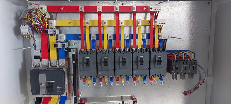 Close-up view of low-voltage switchgear components and circuit breakers in Oman